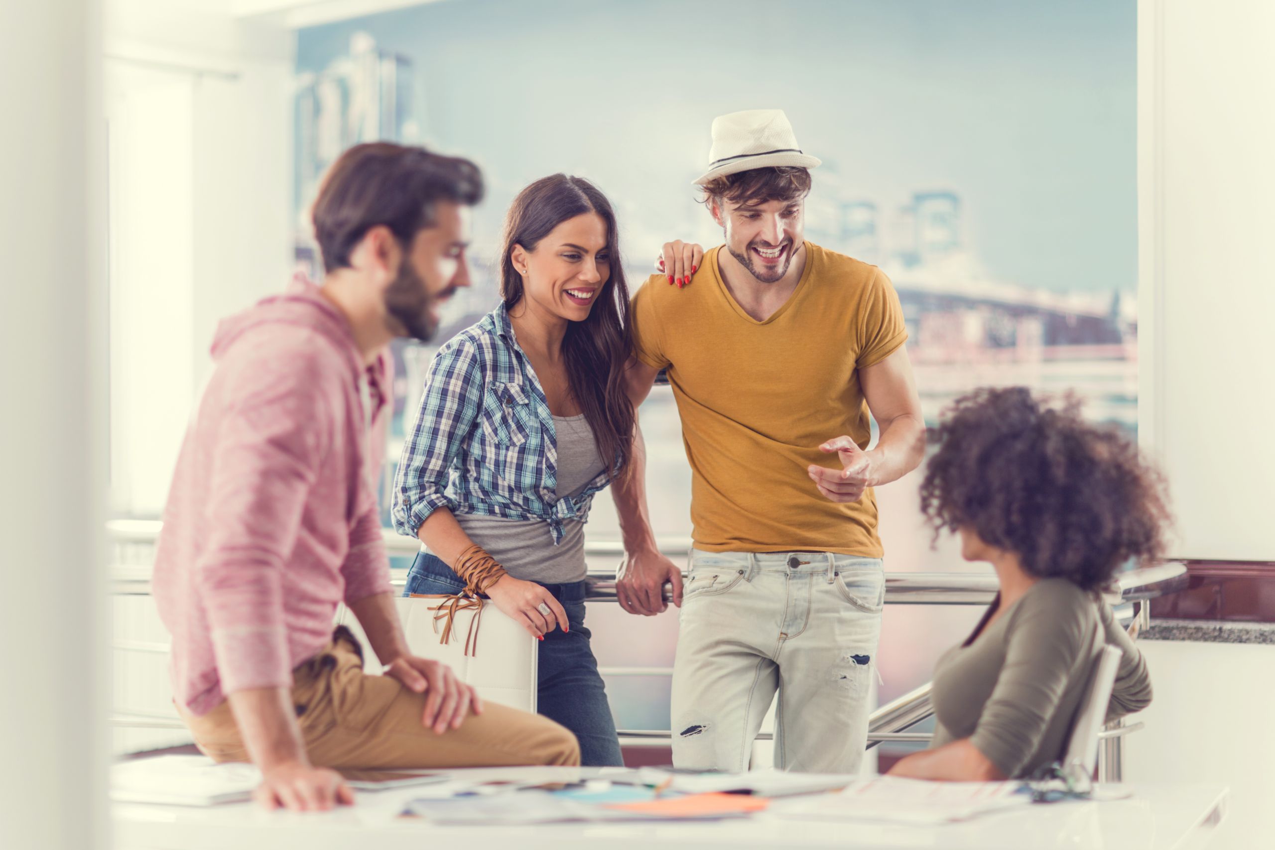 Young happy couple communicating with their colleagues.