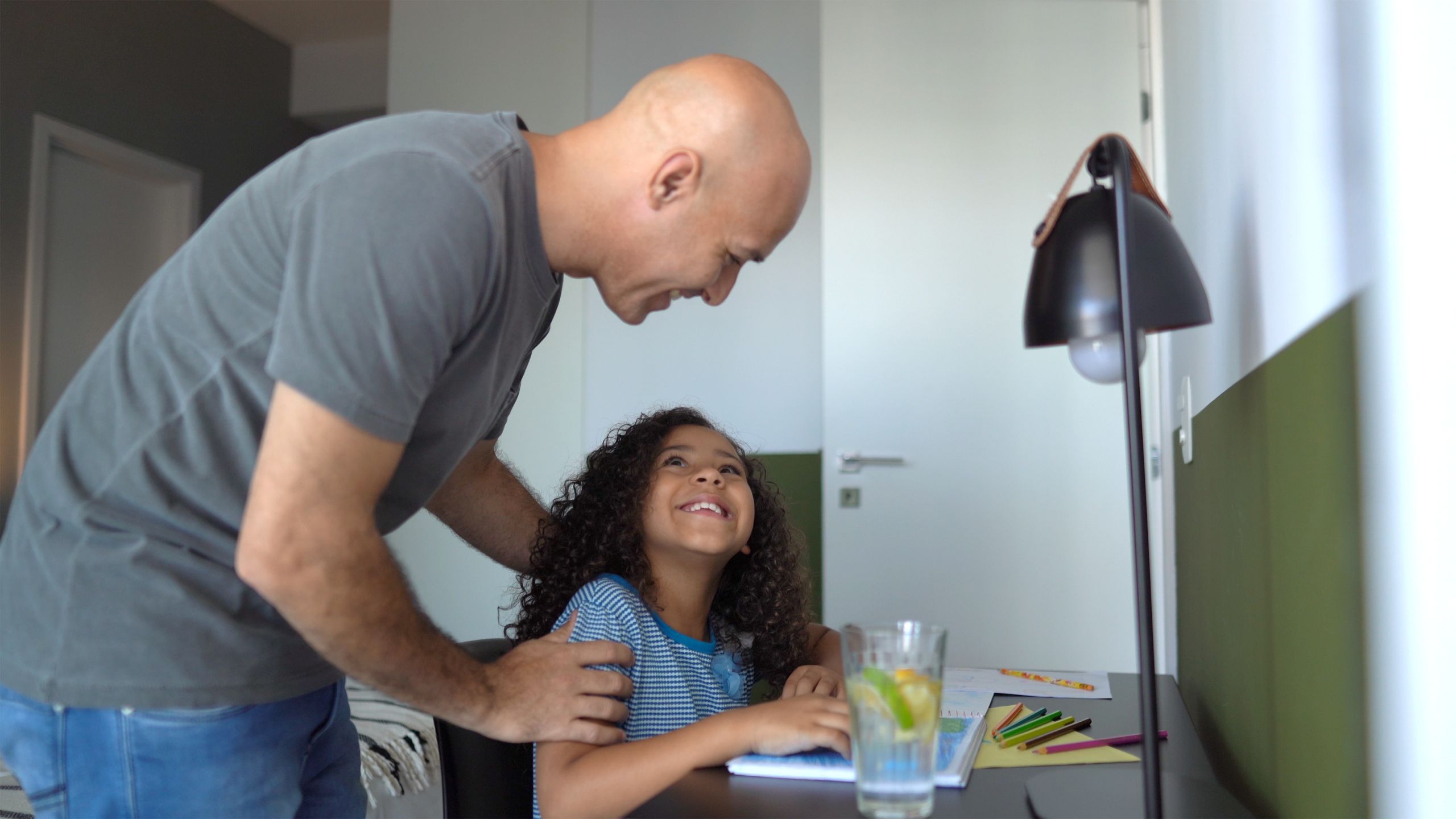 Father helping daughter while she is studying at home
